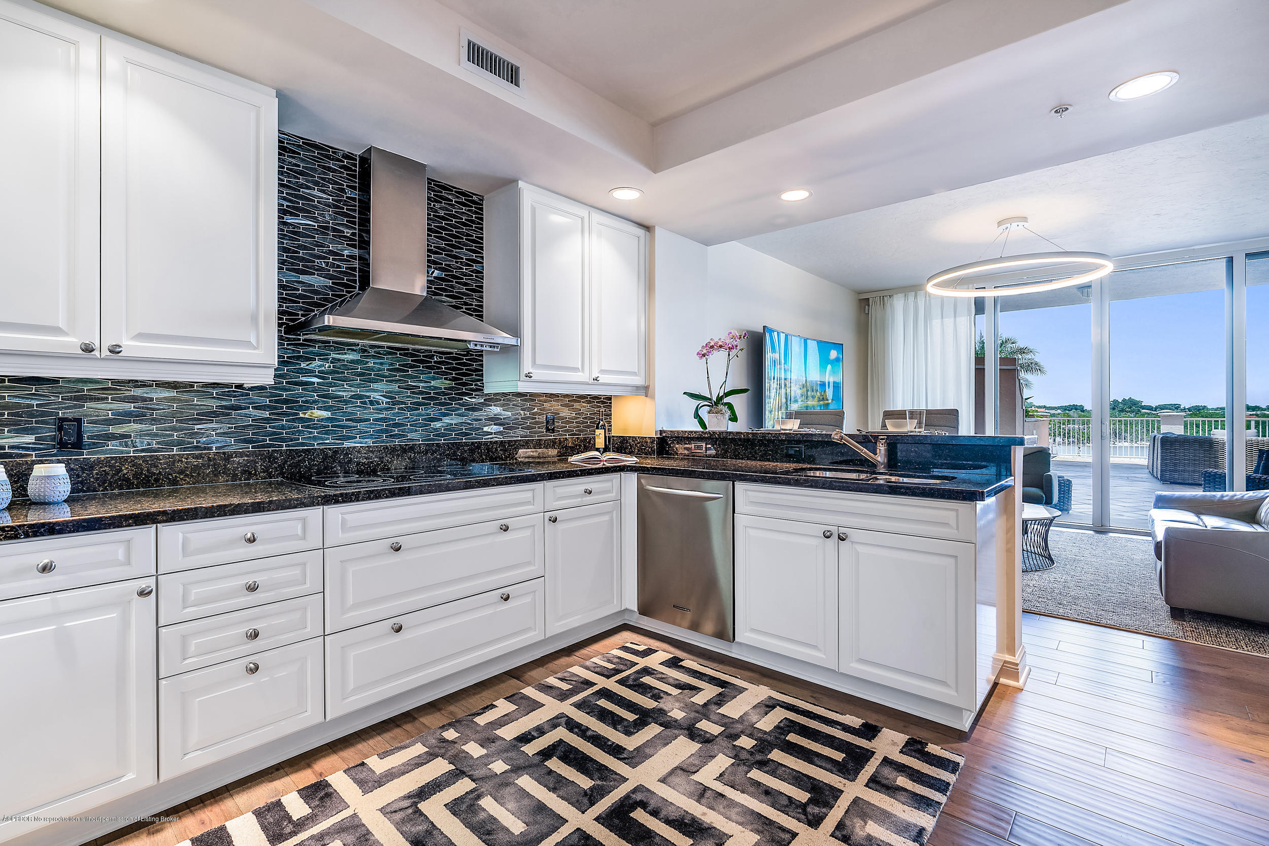 700 Highway 1, Unit 102 Jupiter, FL 33477 - Photo 7 of 36 a kitchen with granite countertop white cabinets and white appliances