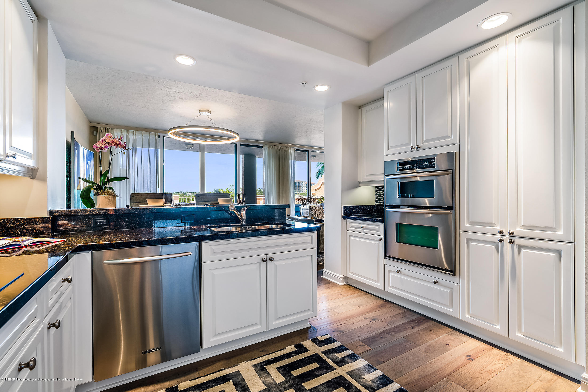 700 Highway 1, Unit 102 Jupiter, FL 33477 - Photo 8 of 36 a kitchen with stainless steel appliances a stove microwave and cabinets