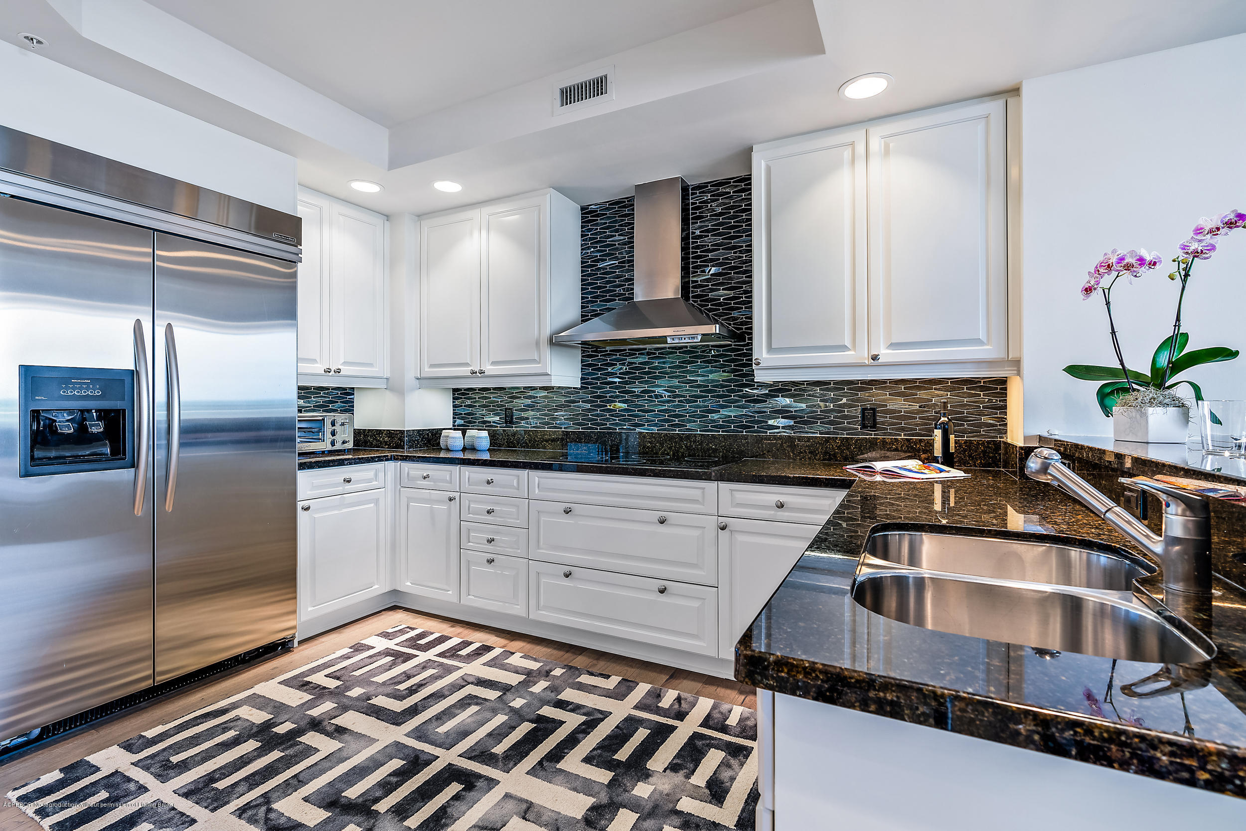 700 Highway 1, Unit 102 Jupiter, FL 33477 - Photo 9 of 36 a kitchen that has a sink and cabinets