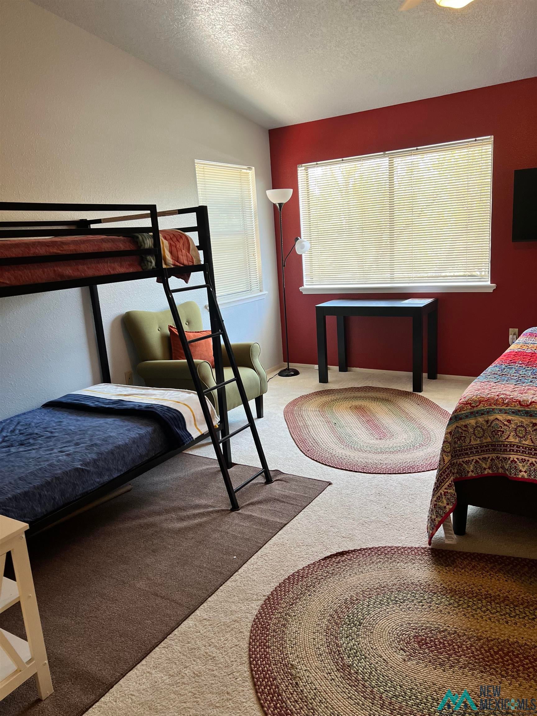 109 Mimbres Road Elephant Butte, NM 87935 - Photo 12 of 27 Carpeted bedroom with a textured ceiling and multiple windows