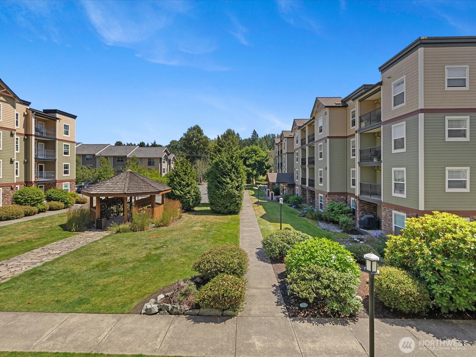 690 32nd Street, Unit B205 Bellingham, WA 98225 - Photo 1 of 40 a view of a building with garden space and sitting area
