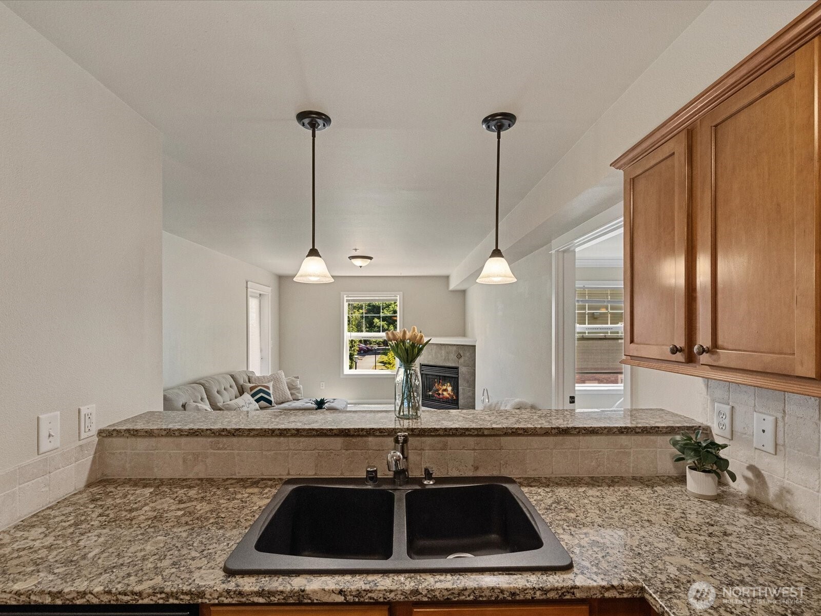 690 32nd Street, Unit B205 Bellingham, WA 98225 - Photo 19 of 40 a kitchen with kitchen island granite countertop counter space a sink and cabinets