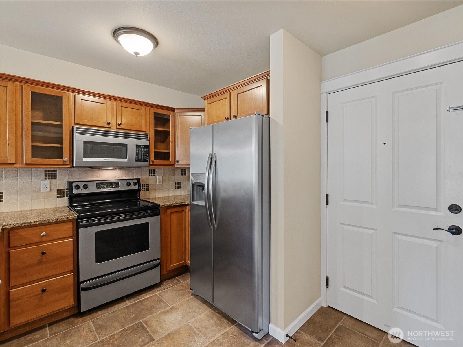 690 32nd Street, Unit B205 Bellingham, WA 98225 - Photo 20 of 40 a metallic refrigerator freezer and a stove top oven
