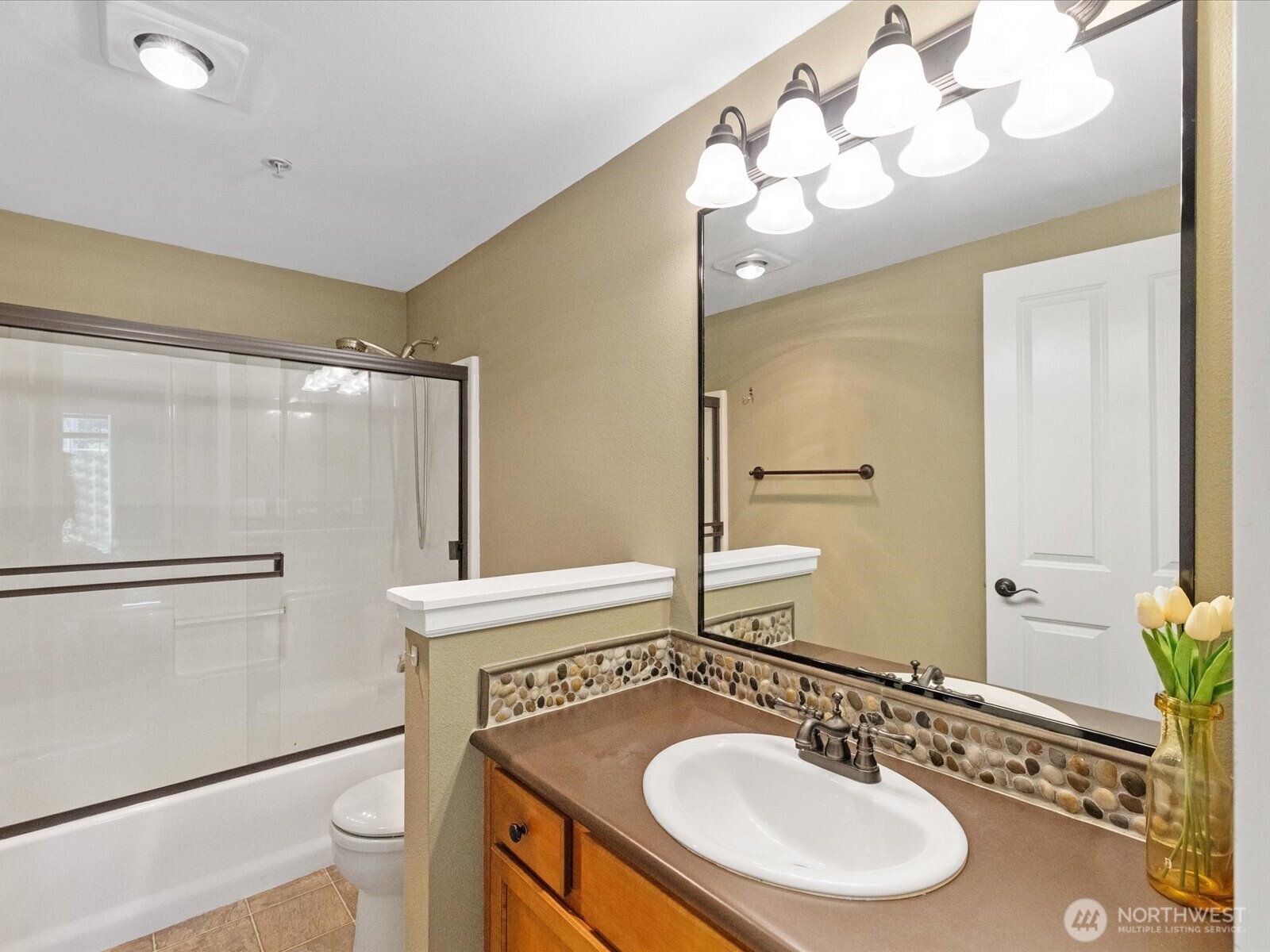 690 32nd Street, Unit B205 Bellingham, WA 98225 - Photo 21 of 40 a bathroom with a sink vanity granite and a mirror