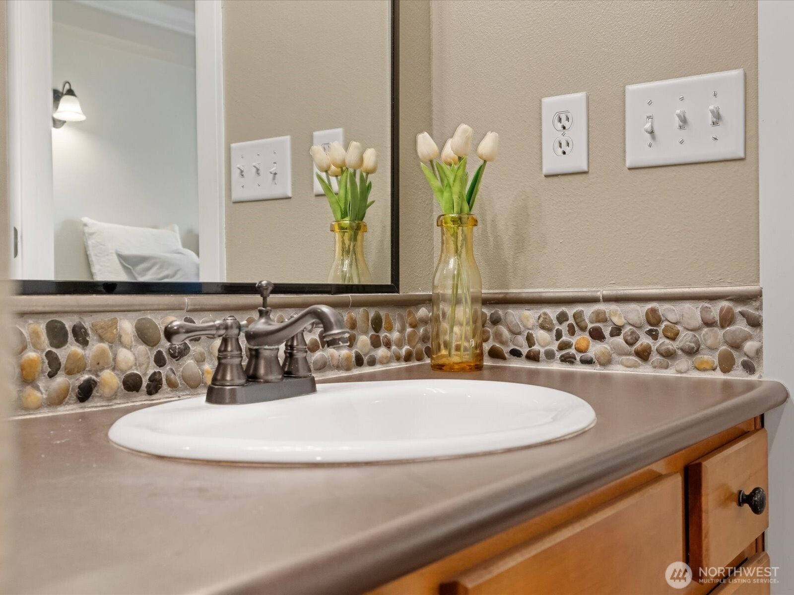 690 32nd Street, Unit B205 Bellingham, WA 98225 - Photo 23 of 40 a bathroom with a sink and a mirror