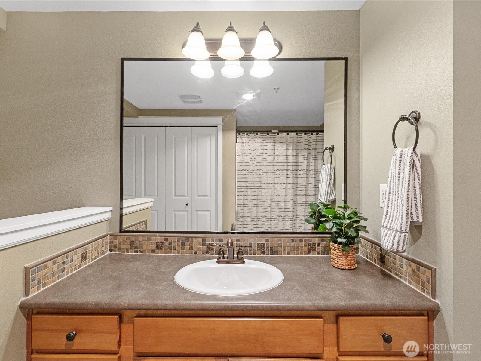 690 32nd Street, Unit B205 Bellingham, WA 98225 - Photo 36 of 40 a bathroom with a granite countertop sink and a mirror