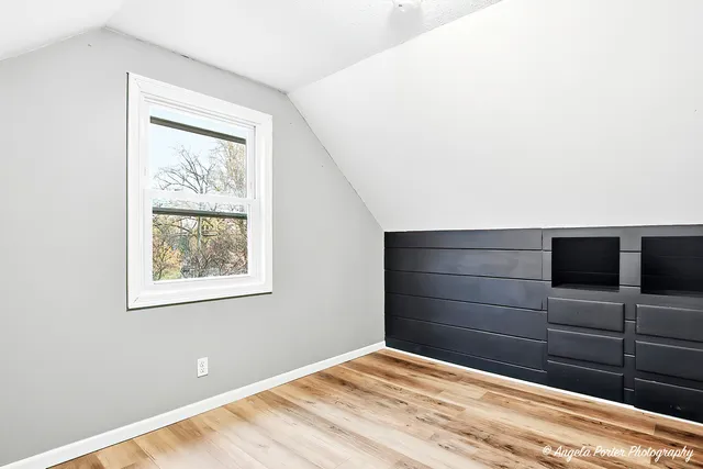 an empty room with wooden floor and closet