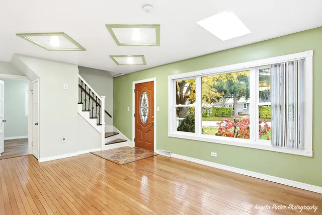 a view of an entryway with wooden floor and windows