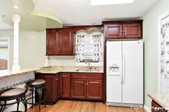 a kitchen with granite countertop a sink and cabinets