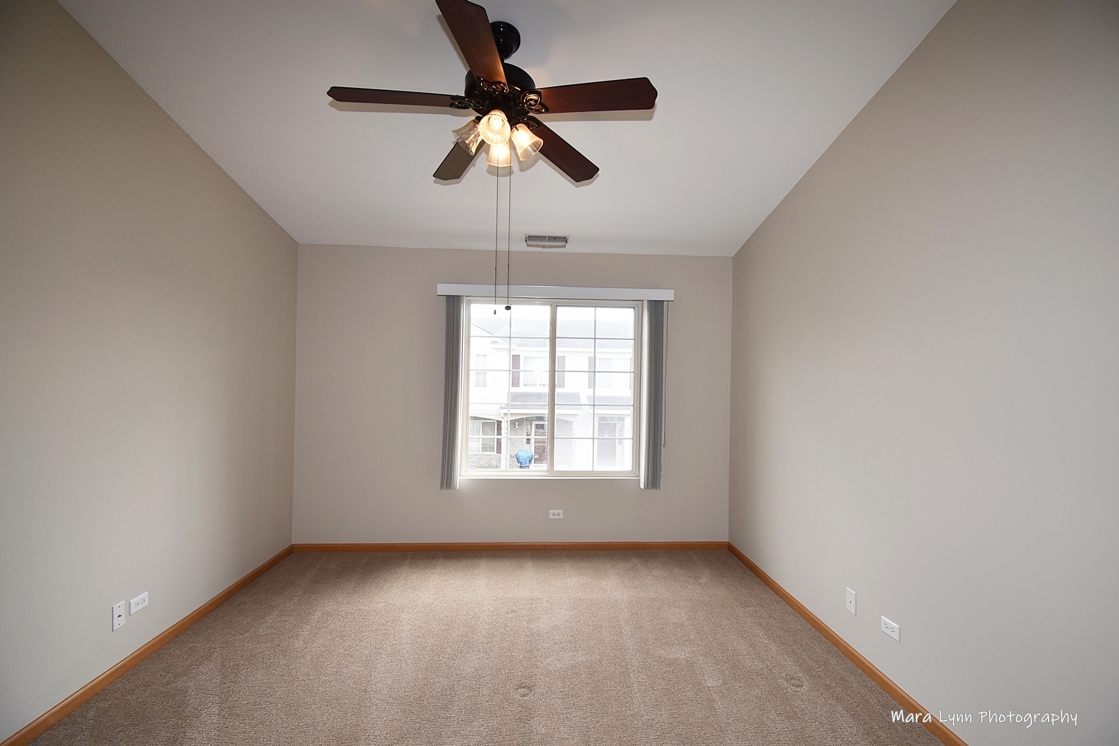 760 County Line Road Aurora, IL 60502 - Photo 17 of 25 an empty room with a window and a ceiling fan
