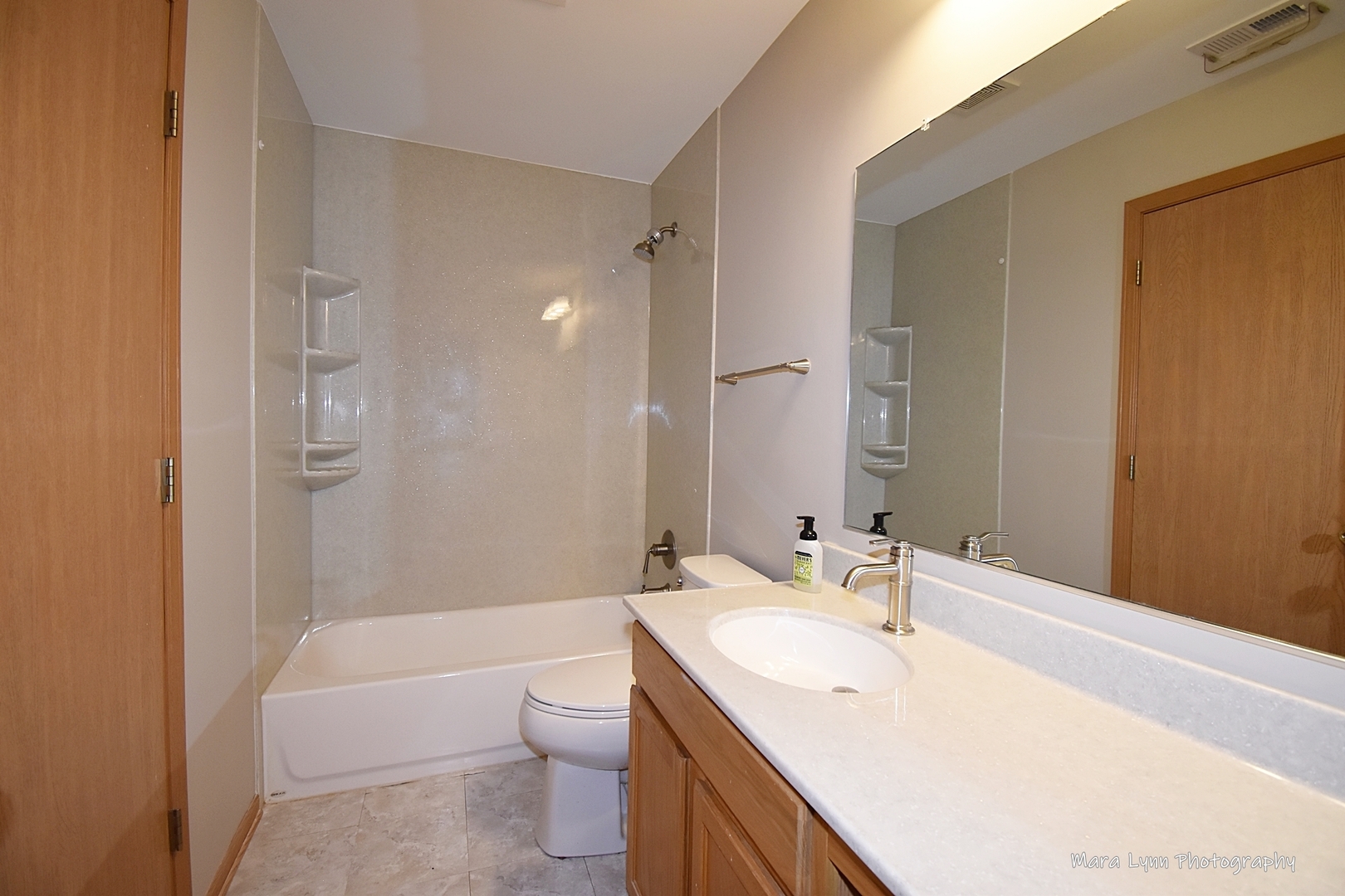 760 County Line Road Aurora, IL 60502 - Photo 19 of 25 a bathroom with a bathtub shower sink vanity mirror and toilet