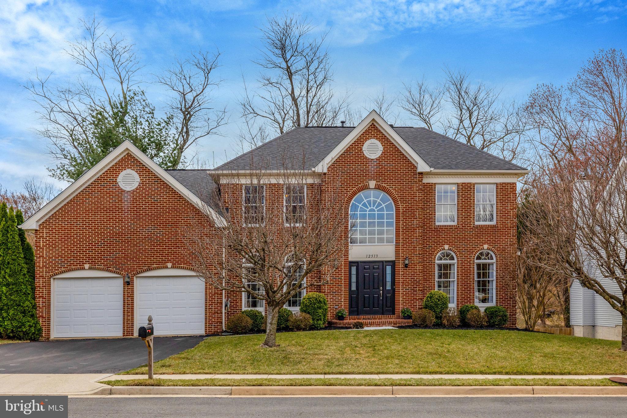 12513 Ridgegate Drive Herndon, VA 20170 - Photo 2 of 72 a front view of a house with a yard
