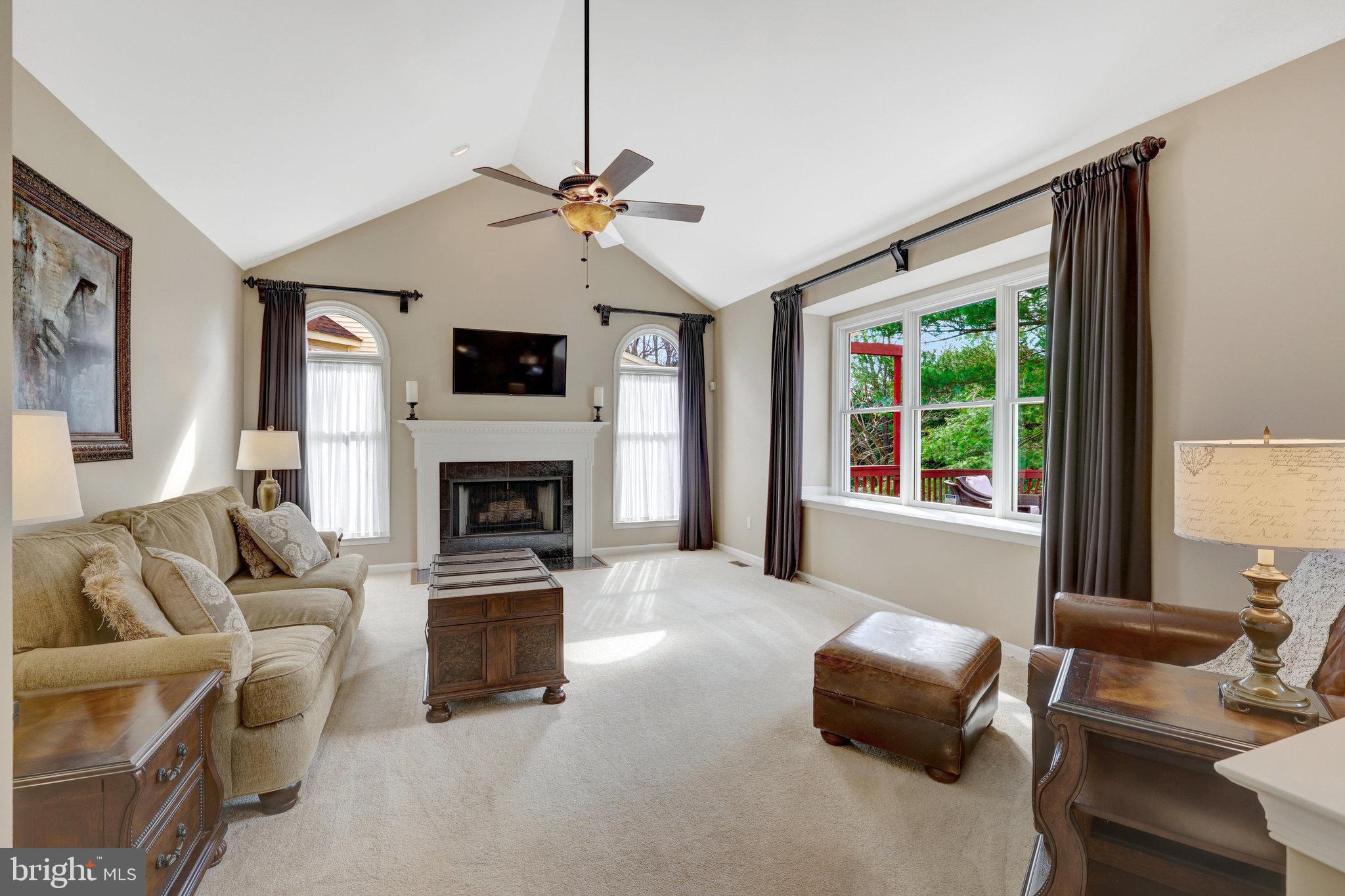 12513 Ridgegate Drive Herndon, VA 20170 - Photo 26 of 72 a living room with furniture a fireplace and a flat screen tv