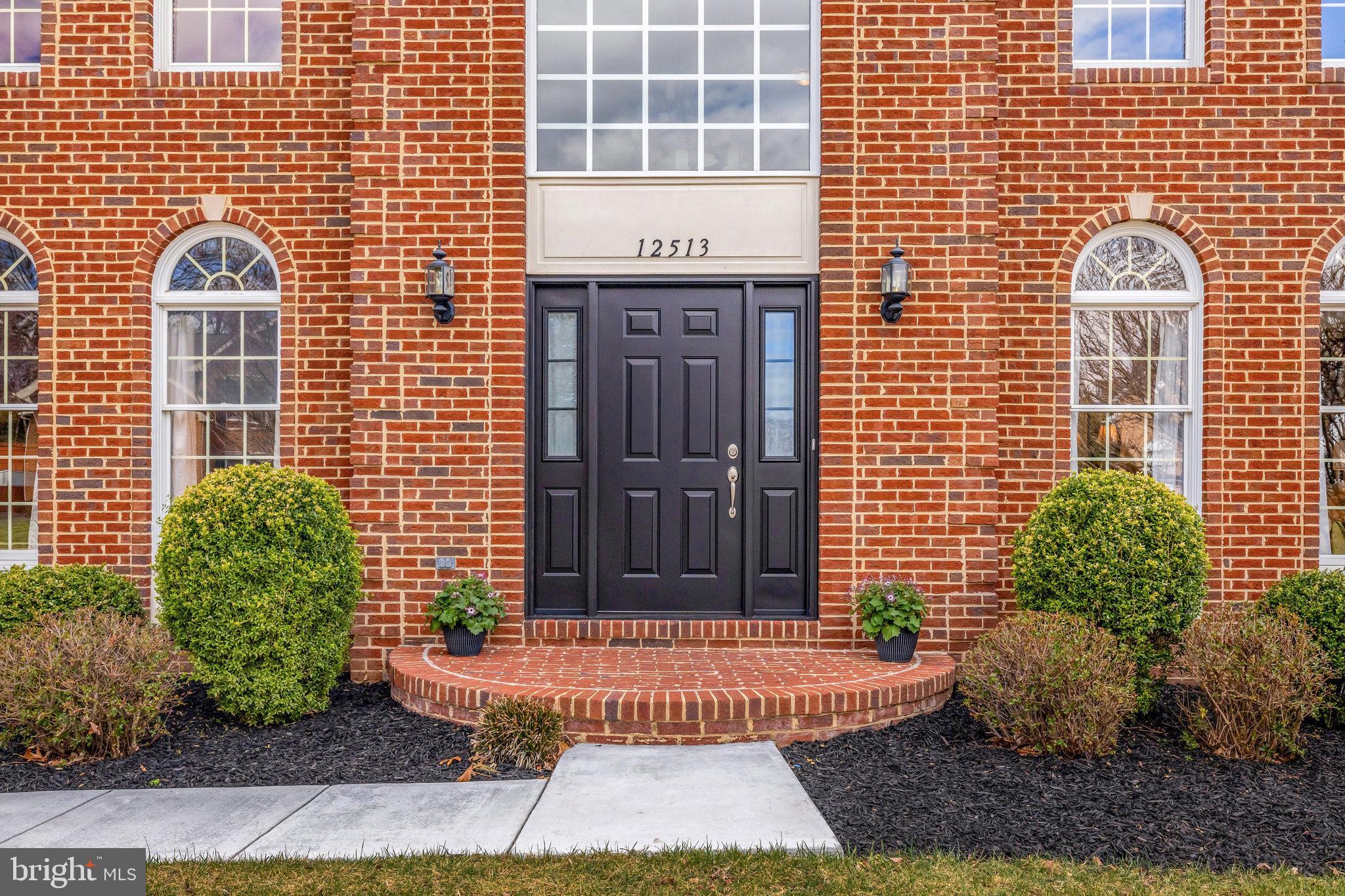 12513 Ridgegate Drive Herndon, VA 20170 - Photo 3 of 72 a front view of a building with a garden
