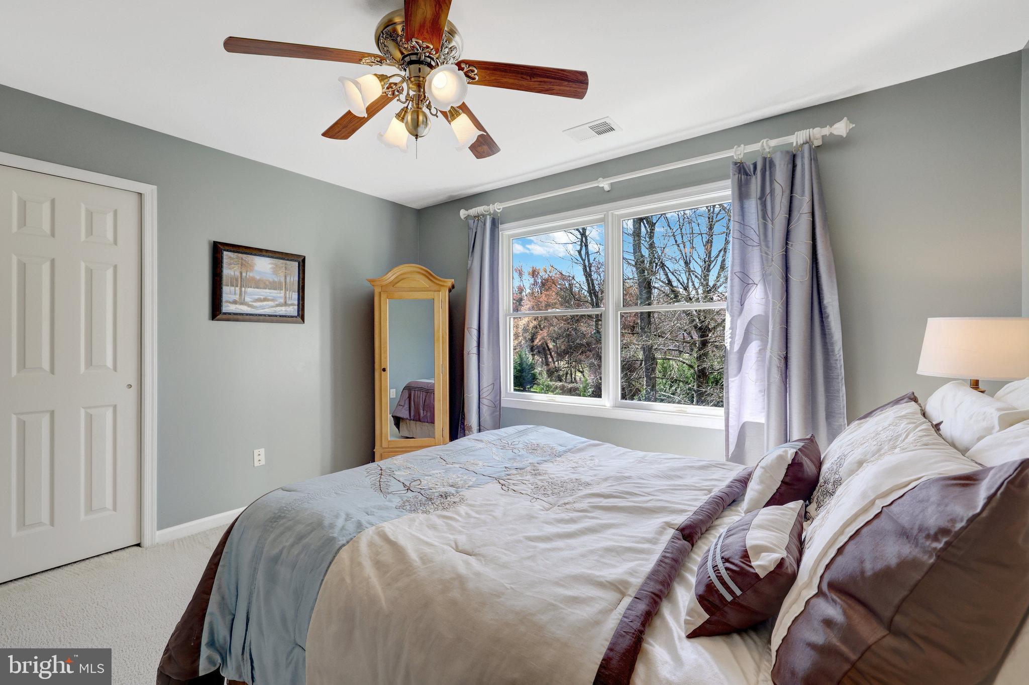 12513 Ridgegate Drive Herndon, VA 20170 - Photo 45 of 72 a bed sitting in a bedroom next to a window