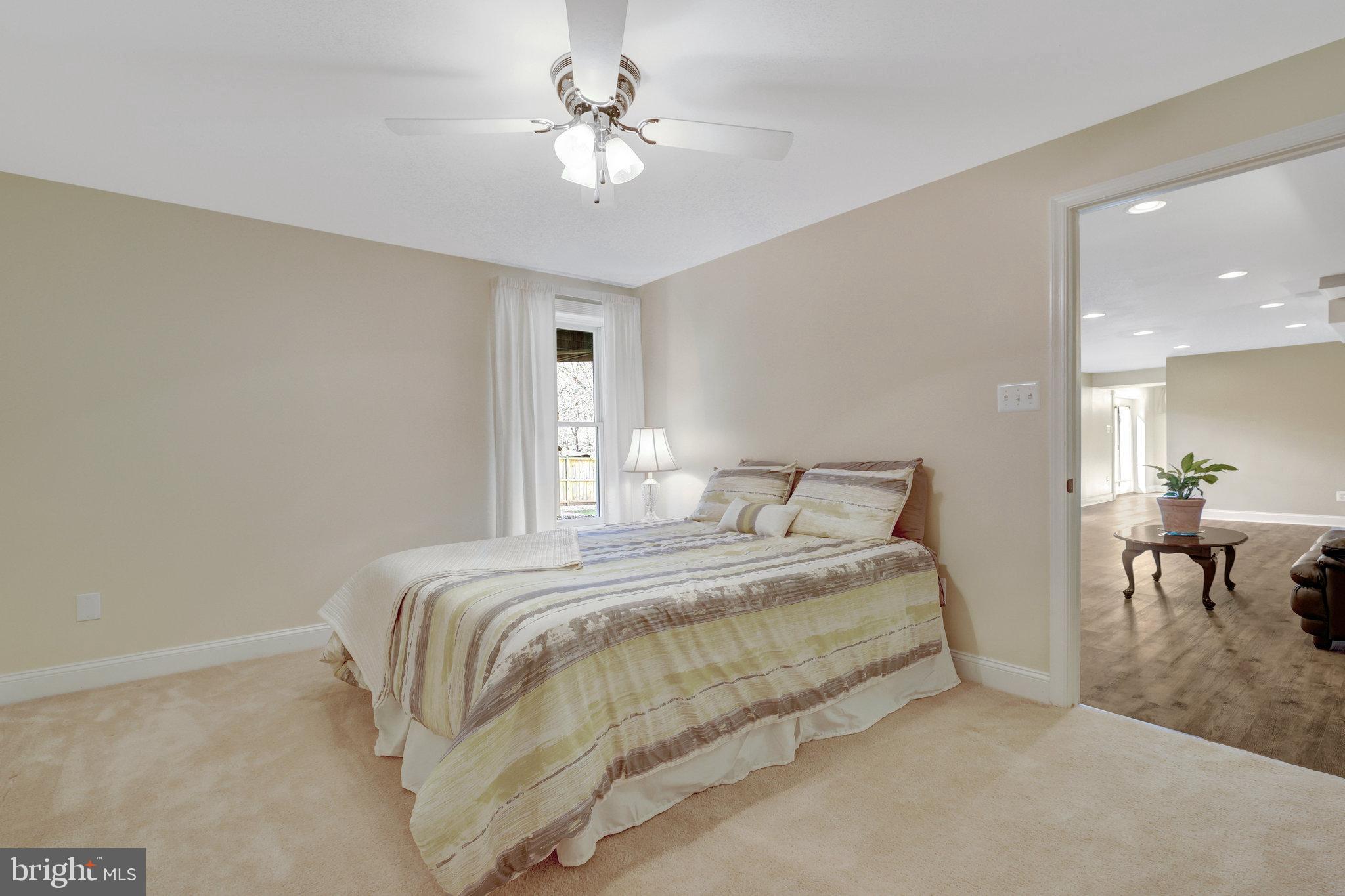 12513 Ridgegate Drive Herndon, VA 20170 - Photo 58 of 72 a bed room with a bed and a chandelier