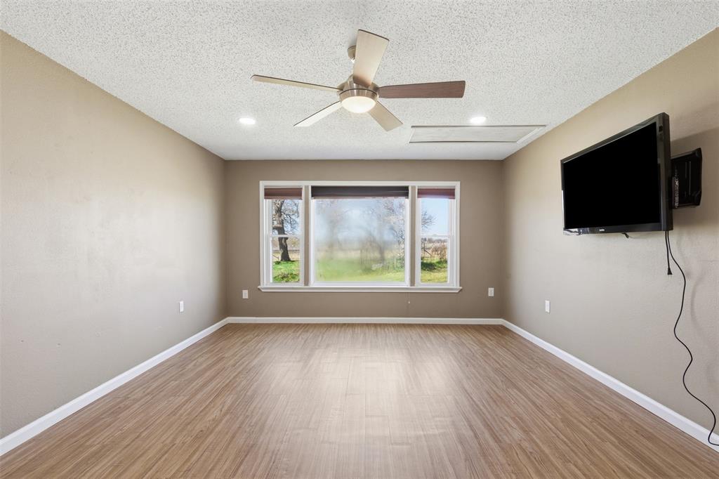 755 County Road 4280 Decatur, TX 76234 - Photo 12 of 36 wooden floor in an empty room with a window