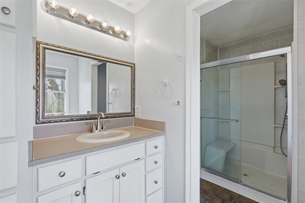 755 County Road 4280 Decatur, TX 76234 - Photo 14 of 36 a bathroom with a shower sink and mirror
