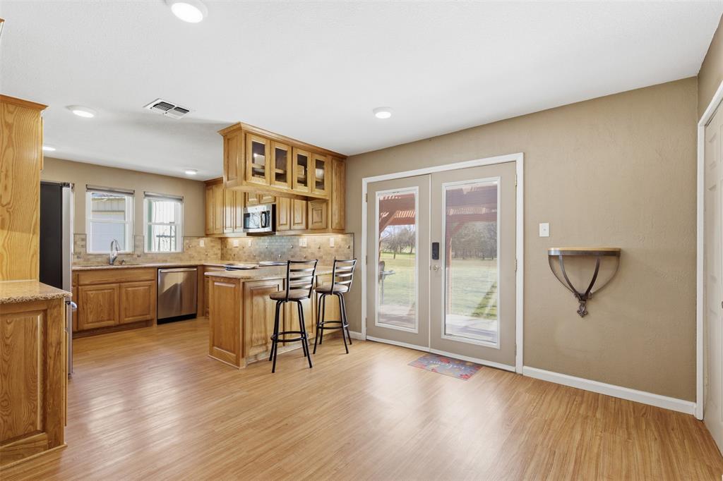 755 County Road 4280 Decatur, TX 76234 - Photo 18 of 36 a view of a kitchen with furniture and wooden floor