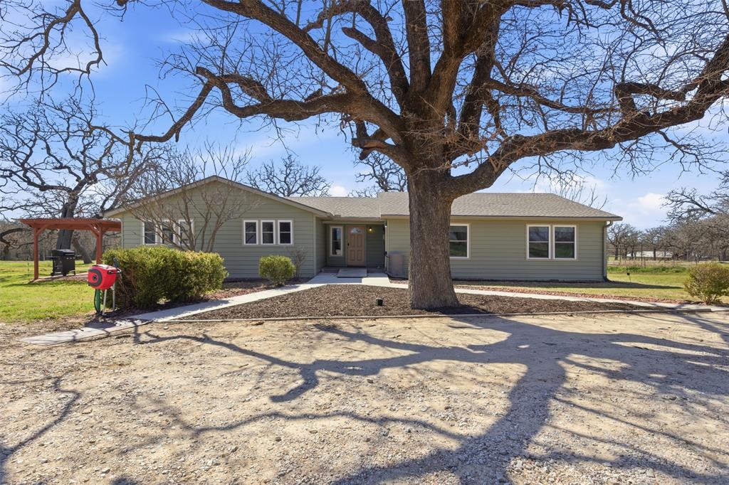 755 County Road 4280 Decatur, TX 76234 - Photo 2 of 36 a front view of a house with a yard and garage