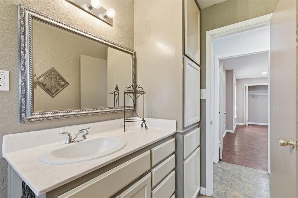 755 County Road 4280 Decatur, TX 76234 - Photo 24 of 36 a bathroom with a sink and a mirror