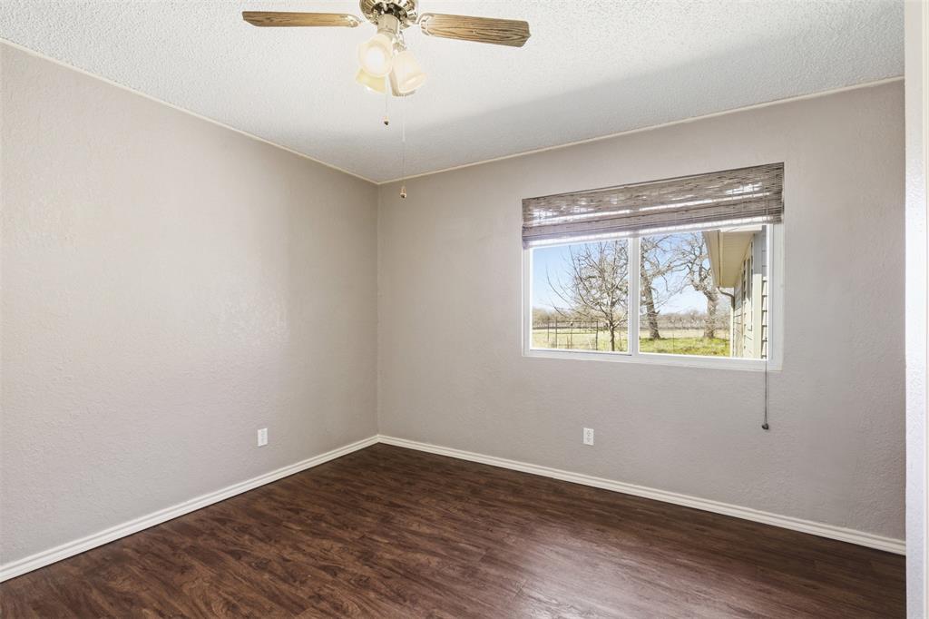 755 County Road 4280 Decatur, TX 76234 - Photo 26 of 36 an empty room with wooden floor and windows