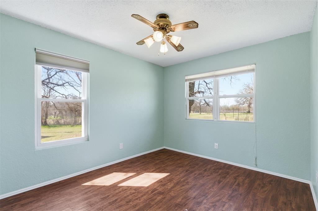 755 County Road 4280 Decatur, TX 76234 - Photo 27 of 36 a view of an empty room with window and wooden floor