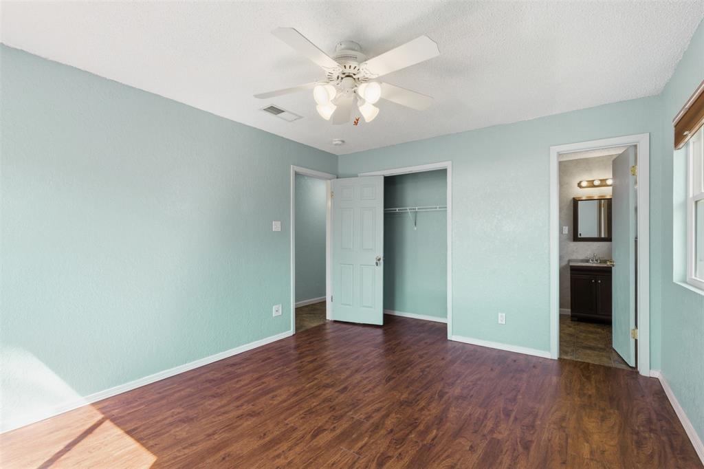 755 County Road 4280 Decatur, TX 76234 - Photo 28 of 36 an empty room with wooden floor and a ceiling fan