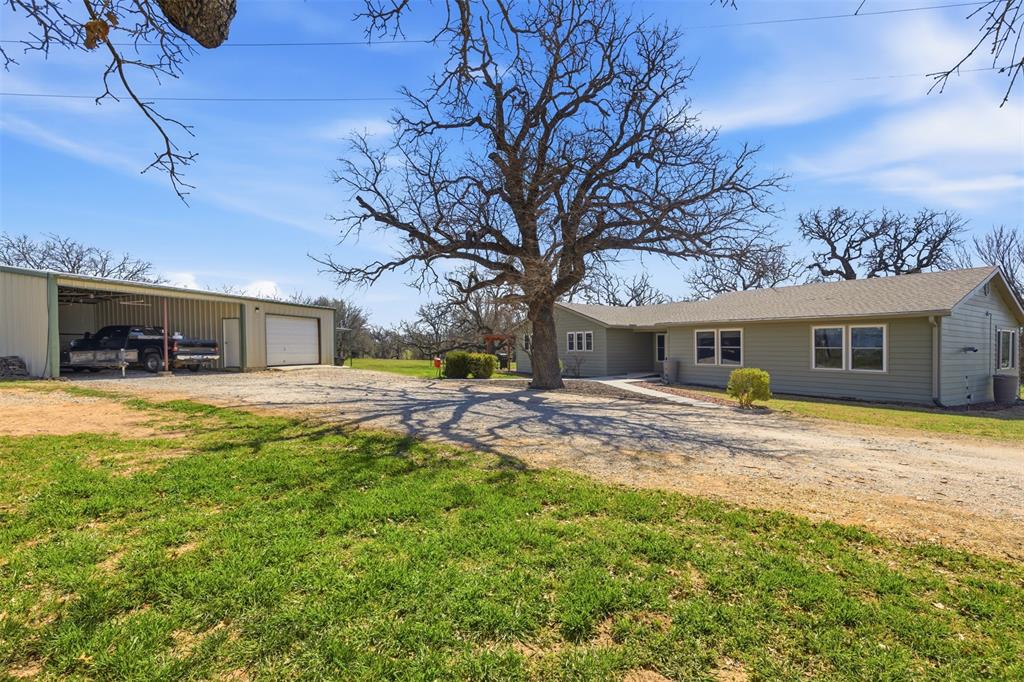 755 County Road 4280 Decatur, TX 76234 - Photo 3 of 36 a view of a yard with a house and a large tree