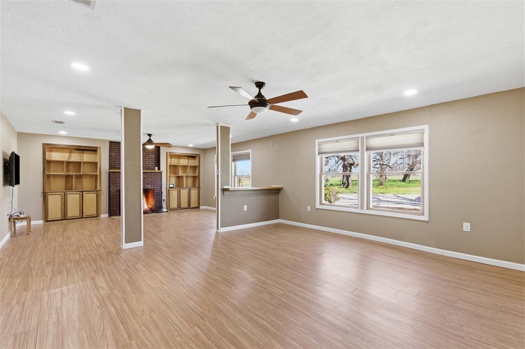 755 County Road 4280 Decatur, TX 76234 - Photo 7 of 36 a view of an empty room with a window and wooden floor