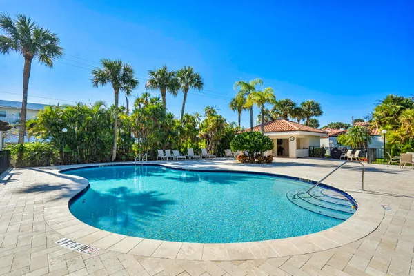 a view of a swimming pool and lounge chairs