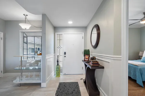 a view of a hallway with entryway wooden floor and front door
