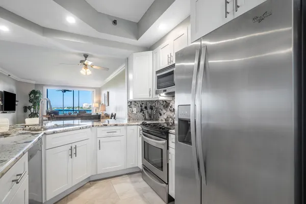 a kitchen with a sink stainless steel appliances and cabinets