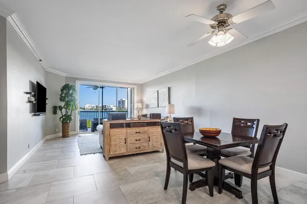 a view of a dining room with furniture and a chandelier fan