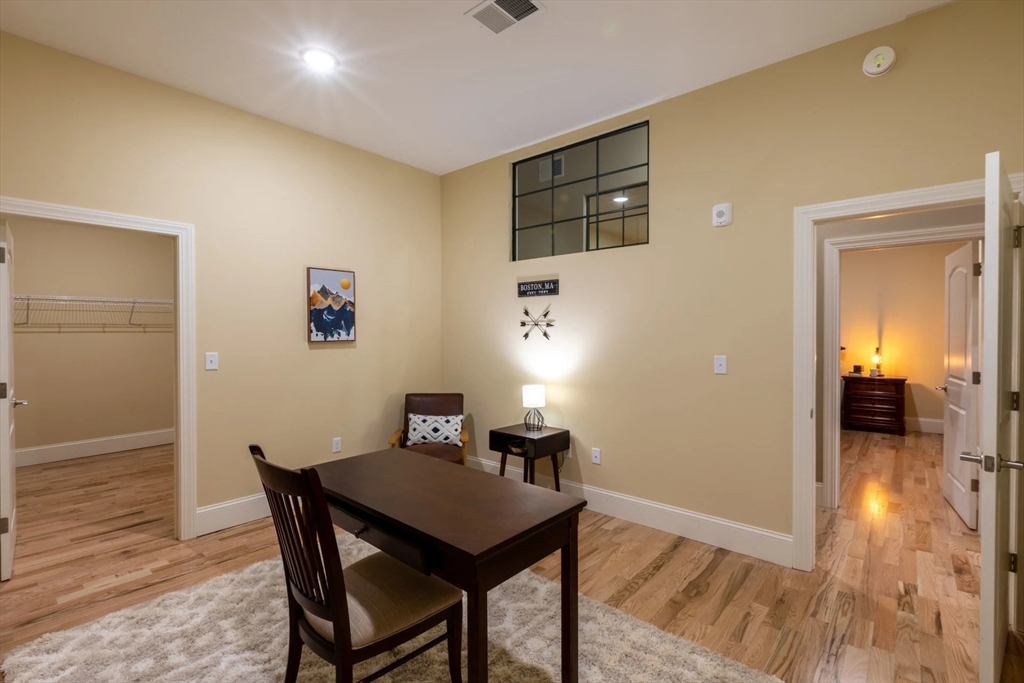 300 Canal Street, Unit 5103 Lawrence, MA 01840 - Photo 13 of 19 a view of a dining room with furniture and wooden floor
