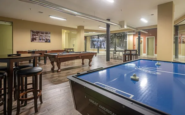 a living room with furniture pool table and a large window