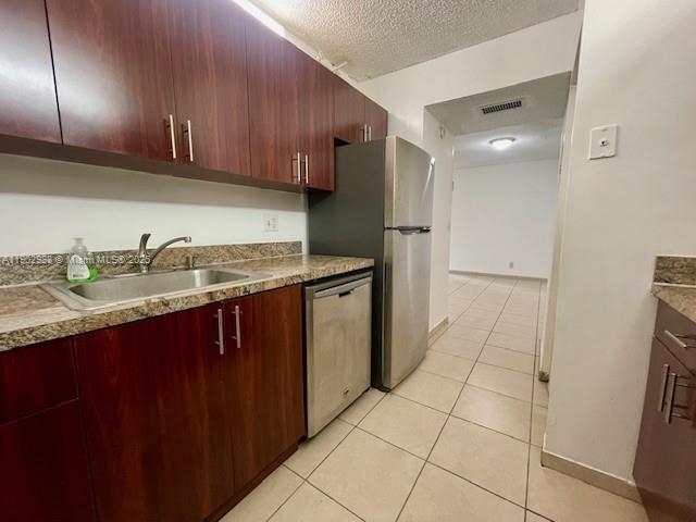8260 Southwest 210th Street, Unit 311 Cutler Bay, FL 33189 - Photo 13 of 17 a kitchen with stainless steel appliances granite countertop a refrigerator and a sink