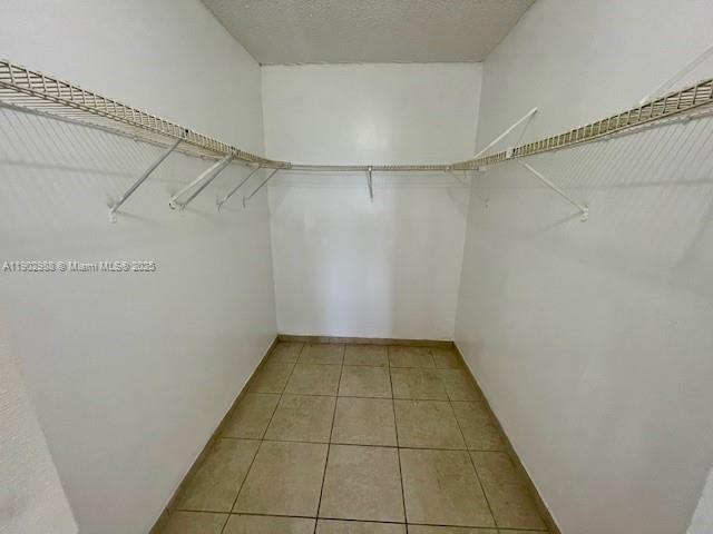 8260 Southwest 210th Street, Unit 311 Cutler Bay, FL 33189 - Photo 4 of 17 a view of a room with racks on the wall
