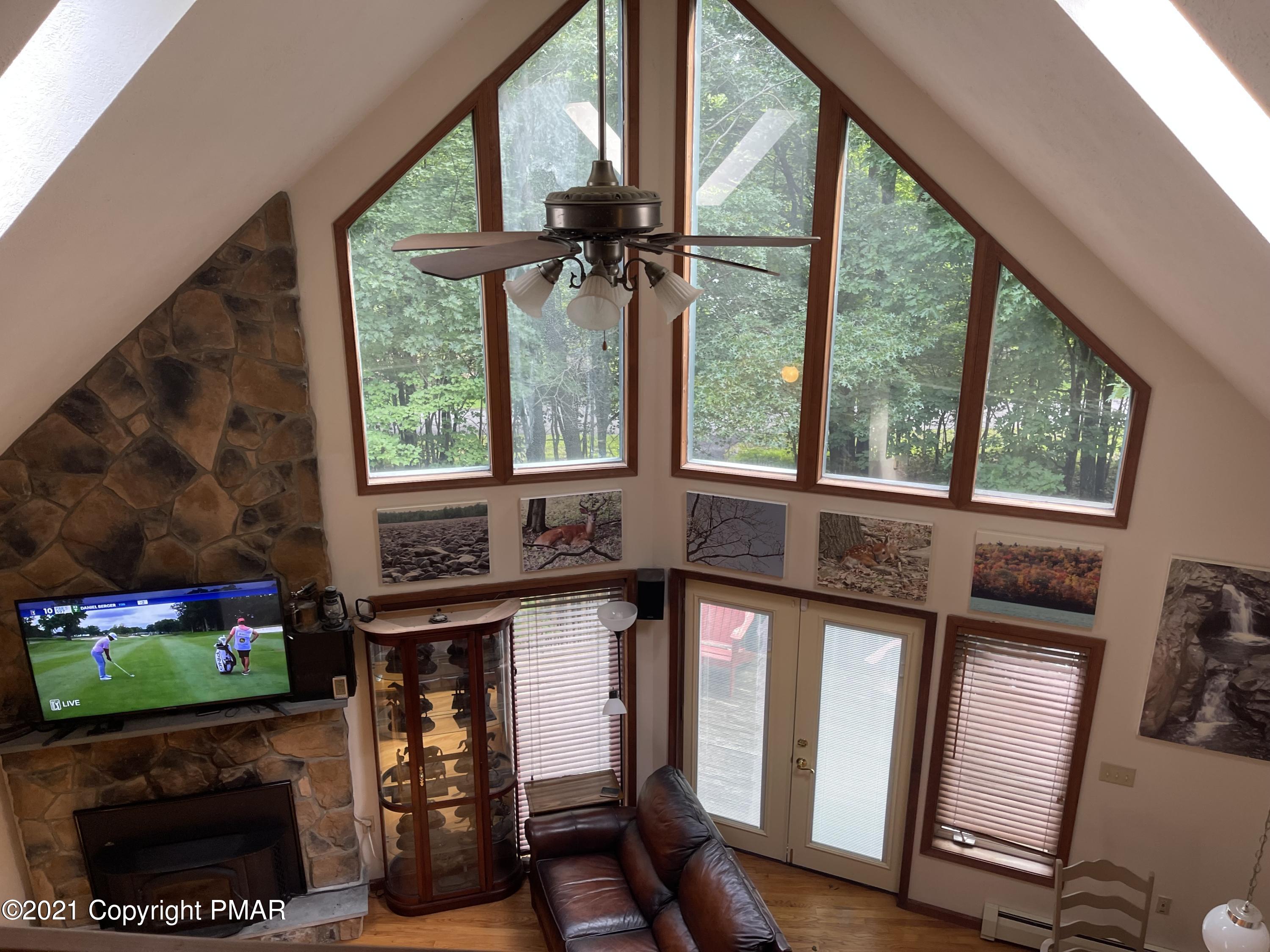 131 Maple Road Blakeslee, PA 18610 - Photo 11 of 35 a view of a porch with furniture and a floor to ceiling window