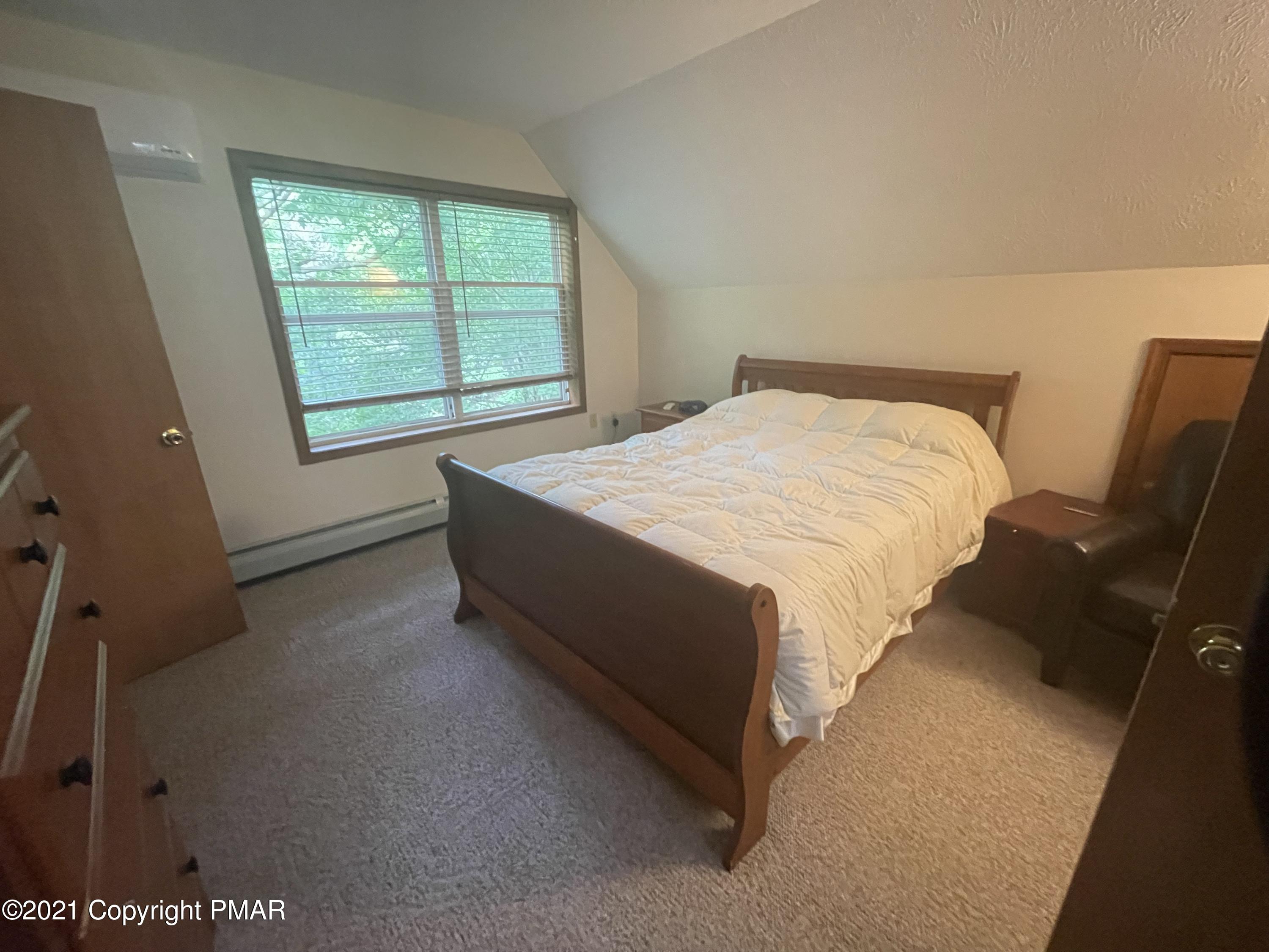 131 Maple Road Blakeslee, PA 18610 - Photo 16 of 35 a bed sitting in a room next to a window