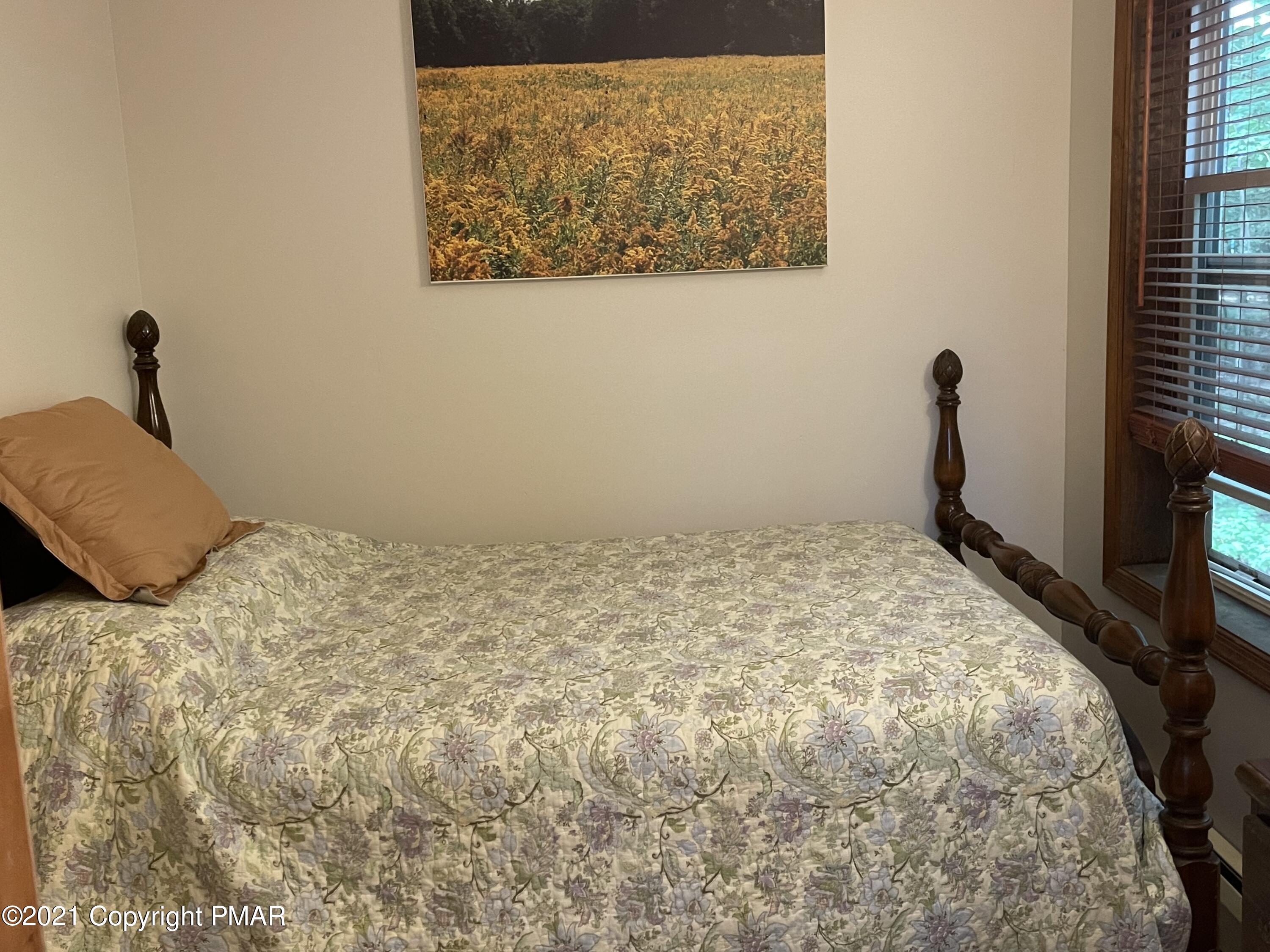 131 Maple Road Blakeslee, PA 18610 - Photo 20 of 35 a bedroom with a bed and a flat screen tv
