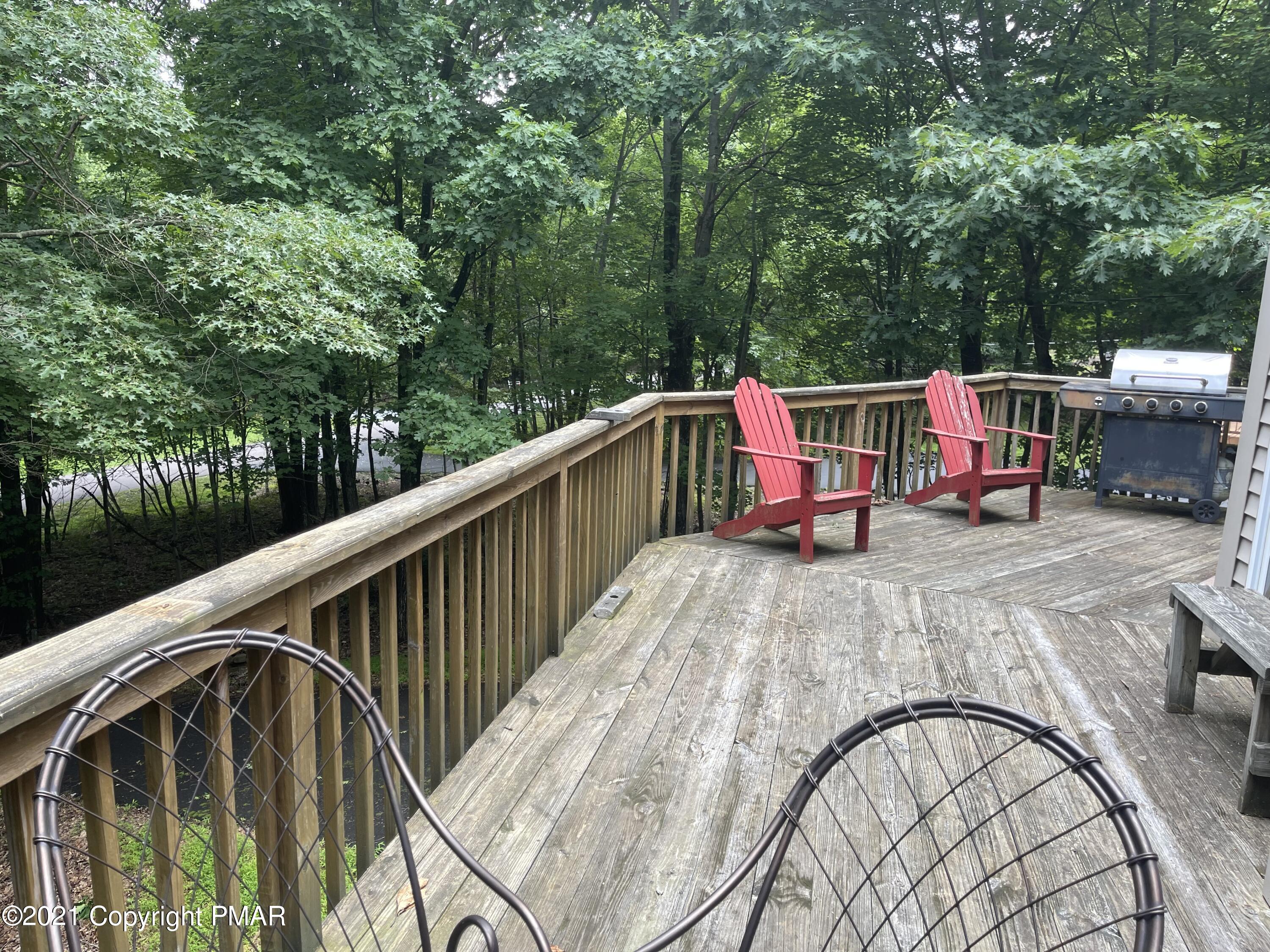 131 Maple Road Blakeslee, PA 18610 - Photo 4 of 35 a view of roof deck with wooden fence and trees