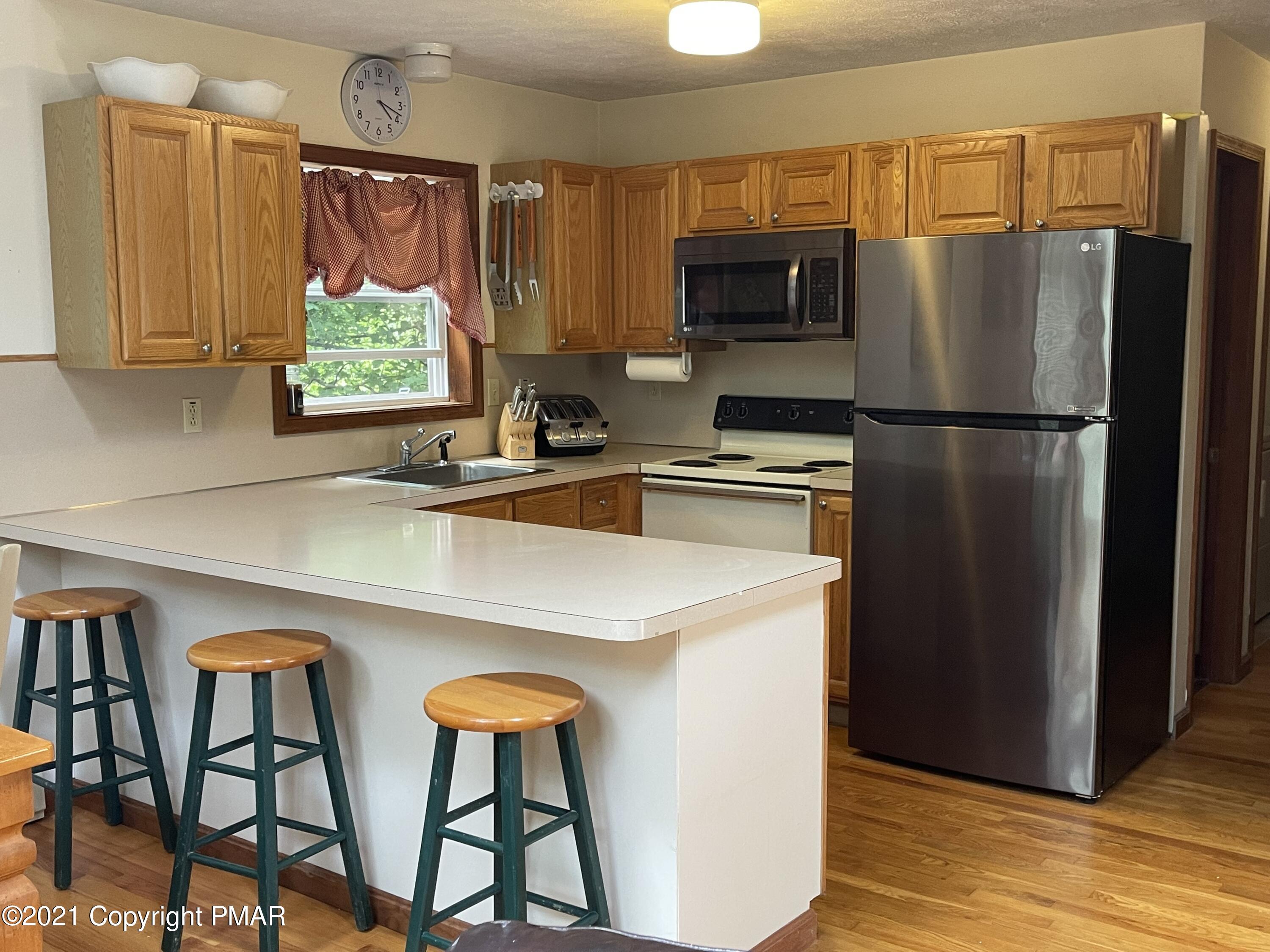 131 Maple Road Blakeslee, PA 18610 - Photo 9 of 35 a kitchen with stainless steel appliances a refrigerator and a sink