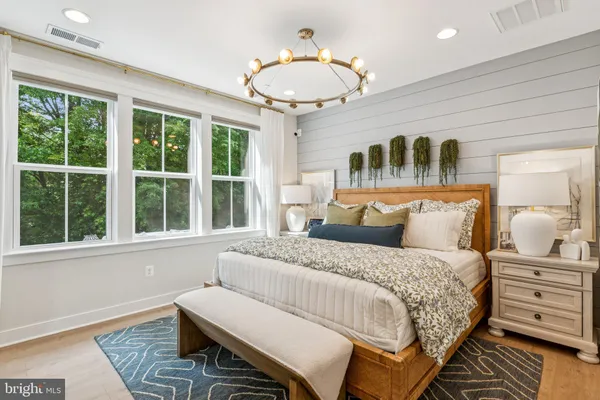 a bedroom with a bed and a large window