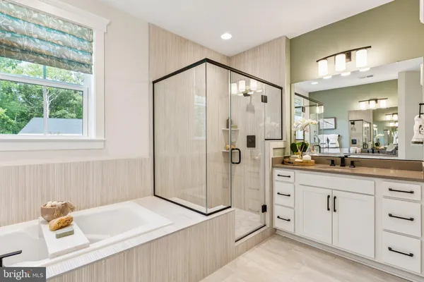 a spacious bathroom with a granite countertop sink a mirror and a shower
