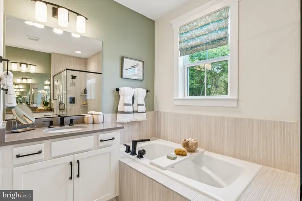 a bathroom with a sink mirror and a window