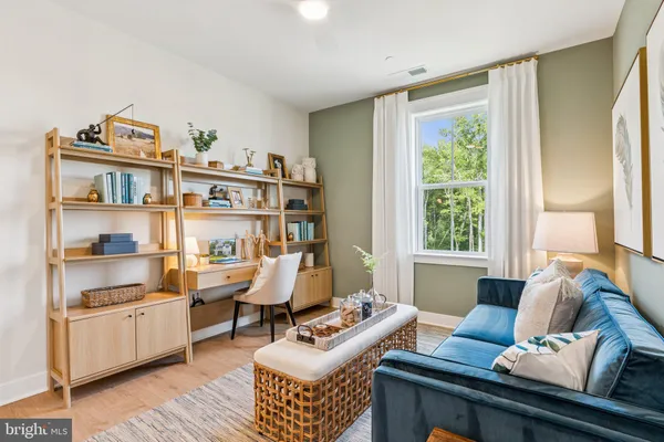 a living room with furniture and a book shelf