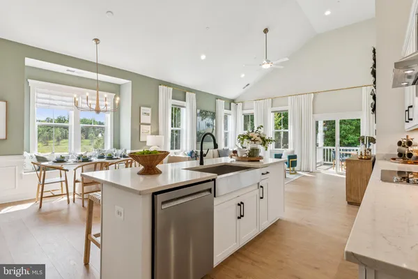 a kitchen with sink stove and cabinets