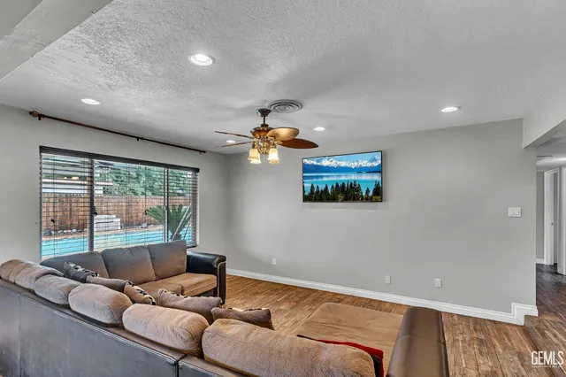 a living room with furniture and a floor to ceiling window