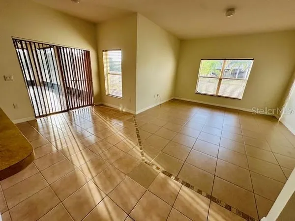 a view of a livingroom with wooden floor and a bathroom space